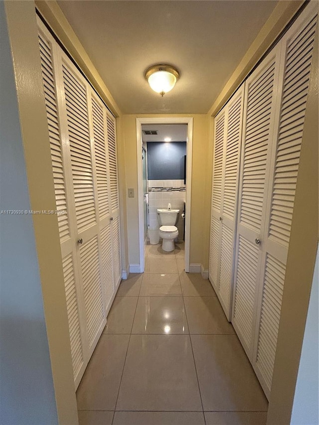 hallway featuring light tile patterned flooring