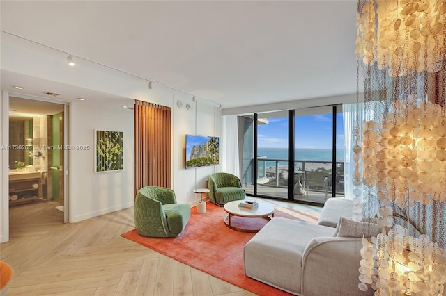 living room with light parquet flooring and floor to ceiling windows