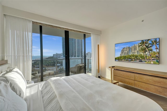 bedroom with hardwood / wood-style flooring and access to outside