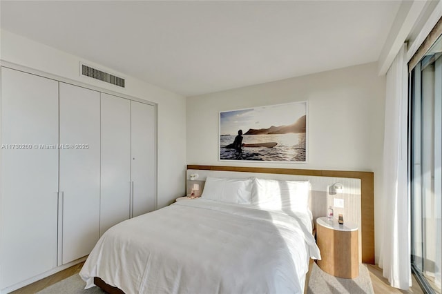 bedroom featuring light hardwood / wood-style flooring and a closet