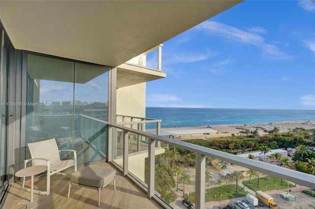 balcony with a beach view and a water view