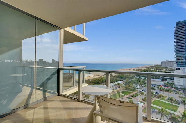 balcony featuring a water view and a view of the beach