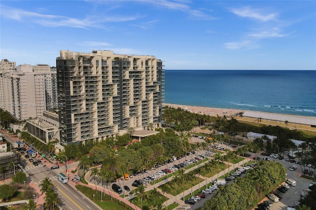 drone / aerial view featuring a water view and a view of the beach