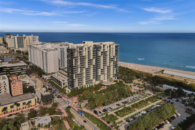 aerial view with a water view and a beach view