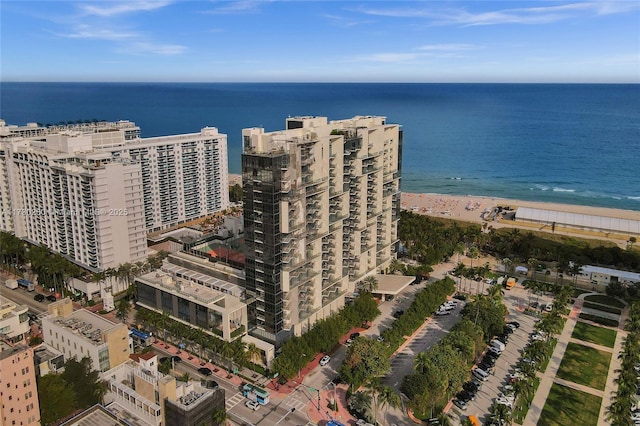 bird's eye view with a water view and a beach view