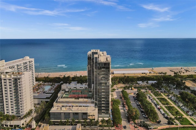 birds eye view of property with a beach view and a water view