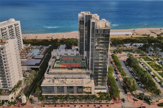 aerial view with a water view and a beach view