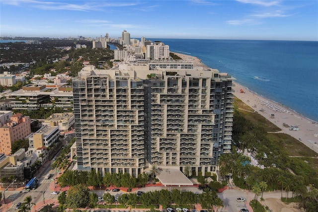 birds eye view of property featuring a water view and a beach view