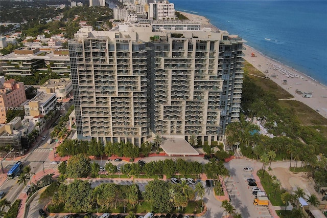 view of building exterior with a water view and a beach view