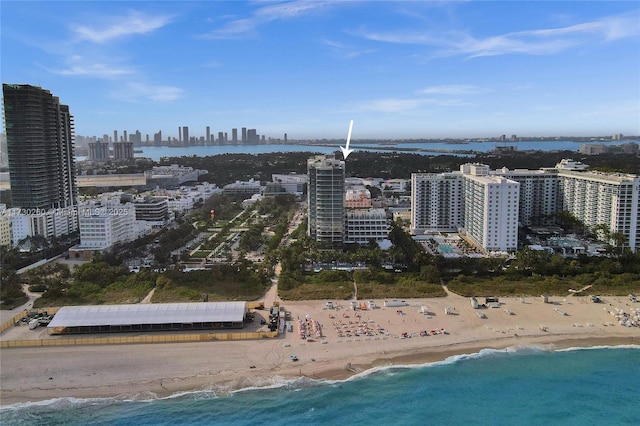 drone / aerial view with a beach view and a water view