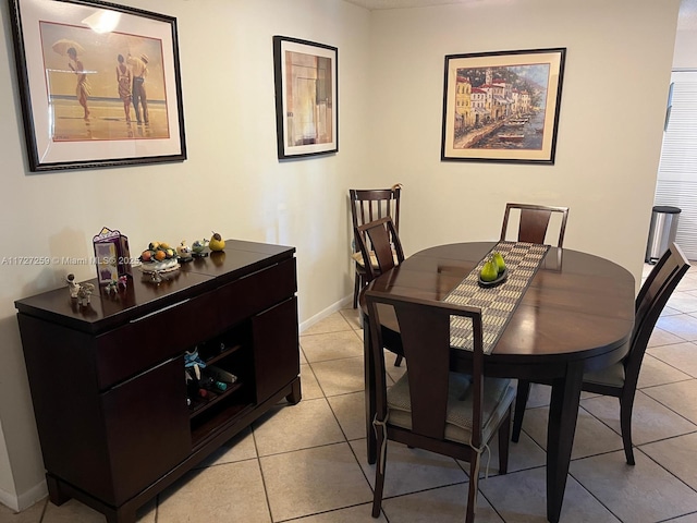 dining space featuring light tile patterned floors