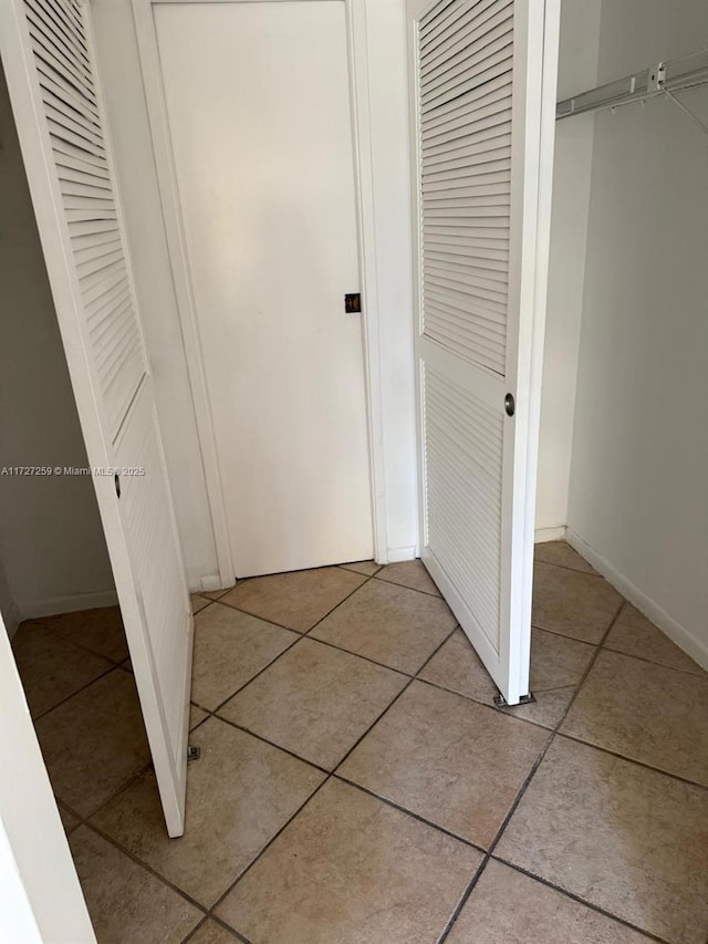 9040 SW 125th Ave Unit D210, Miami, FL 33186 - hall featuring light tile patterned floors and baseboards