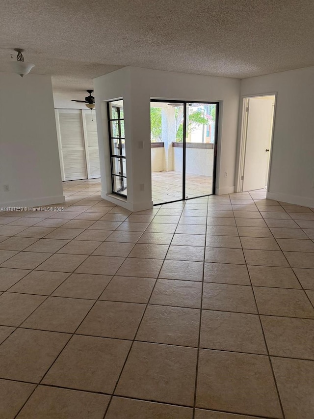 9040 SW 125th Ave Unit D210, Miami, FL 33186 - spare room with a textured ceiling, light tile patterned floors, a ceiling fan, and baseboards