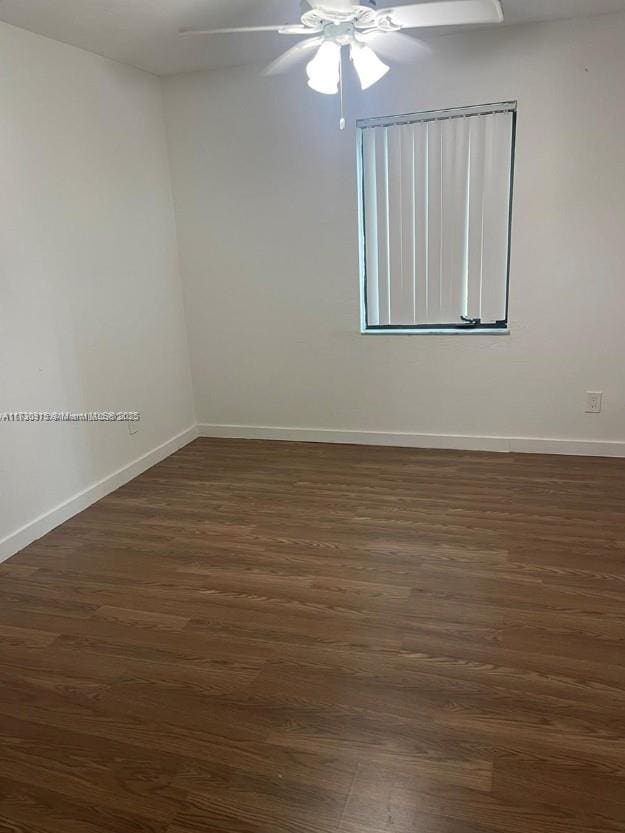 spare room featuring ceiling fan and dark hardwood / wood-style floors