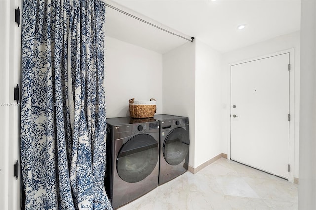 washroom with washing machine and clothes dryer, baseboards, recessed lighting, and laundry area