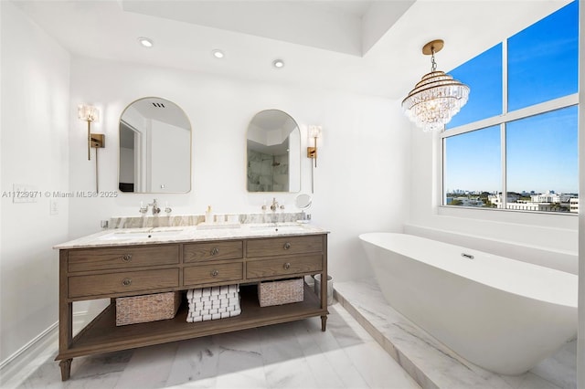 bathroom featuring a washtub, vanity, and a chandelier