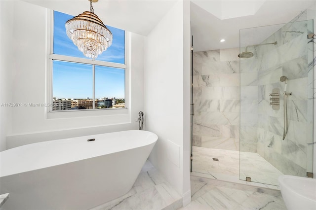 full bath with a freestanding bath, marble finish floor, a marble finish shower, and recessed lighting