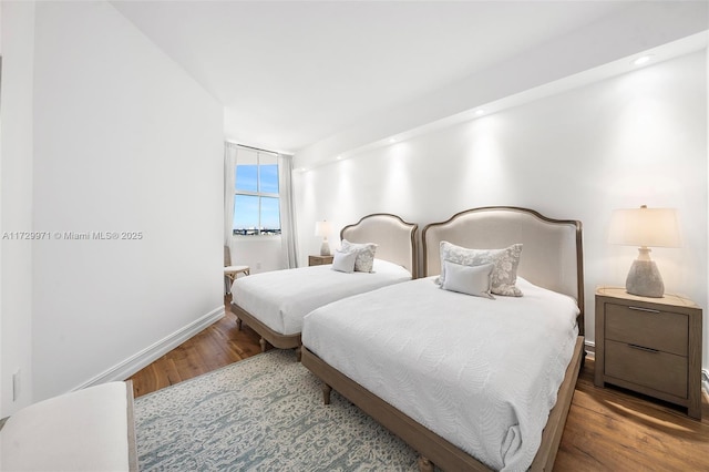 bedroom with wood finished floors and baseboards