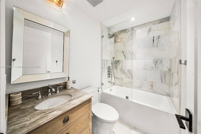 full bathroom with tiled shower / bath, vanity, and toilet