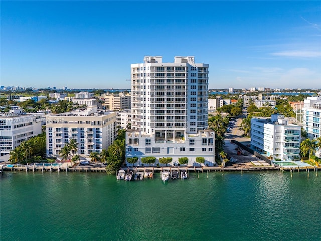 drone / aerial view featuring a view of city and a water view