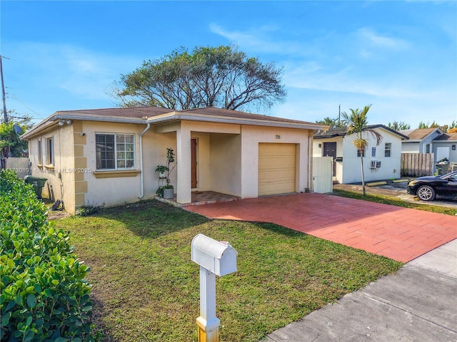 single story home with a garage and a front yard