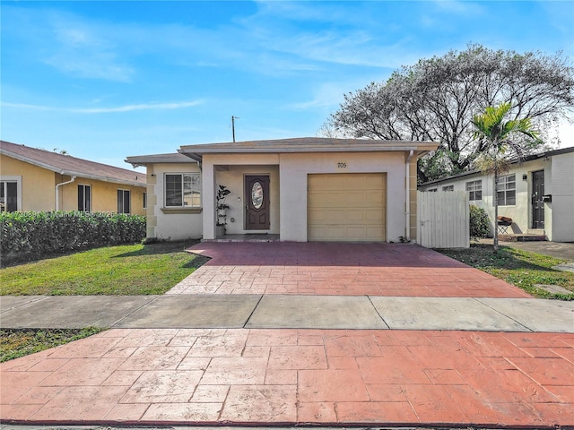 ranch-style home with a garage and a front lawn