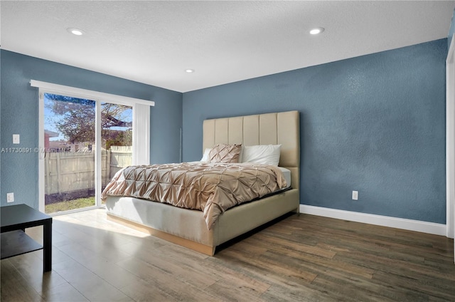 bedroom featuring hardwood / wood-style floors and access to outside