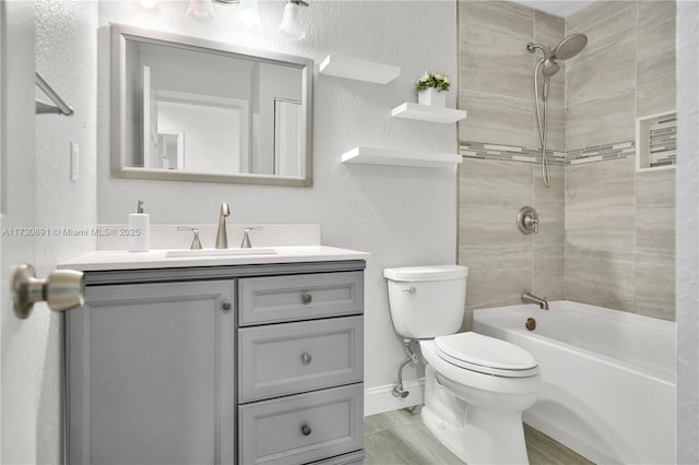 full bathroom with tiled shower / bath combo, toilet, and vanity