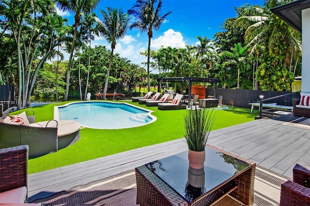 pool featuring a fenced backyard, an outdoor living space, a lawn, a wooden deck, and a pergola