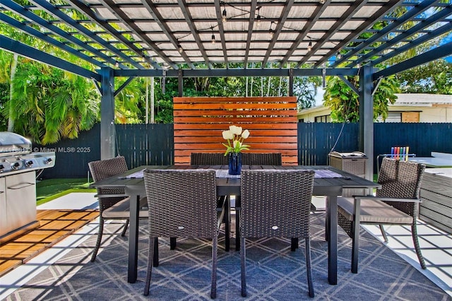 view of patio featuring outdoor dining area, fence, and a pergola