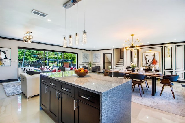 kitchen with a chandelier, light stone counters, visible vents, open floor plan, and decorative light fixtures