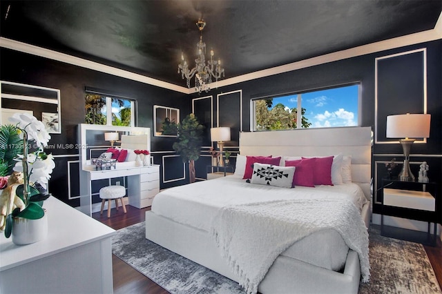 bedroom featuring an inviting chandelier and wood finished floors