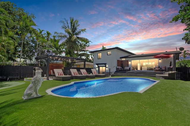 pool at dusk with outdoor lounge area, fence, a lawn, a fenced in pool, and a pergola