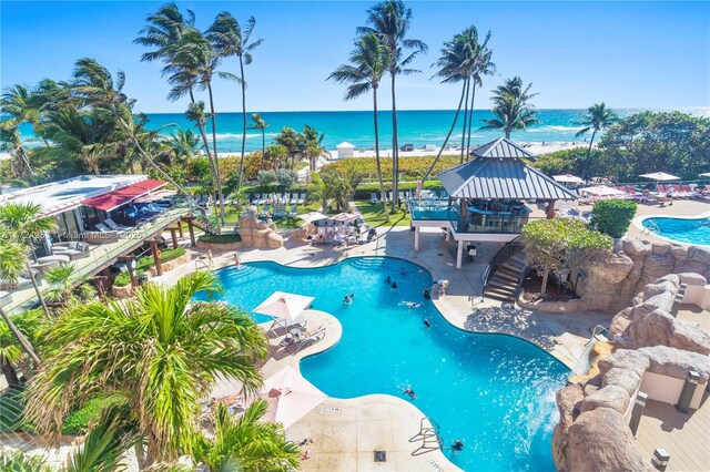 view of pool with a gazebo, a water view, and a patio