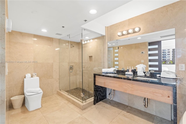 bathroom featuring tile walls, vanity, toilet, and walk in shower