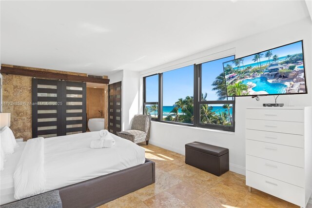 5225 Collins Ave Unit 501, Miami Beach, FL 33140 - bedroom with baseboards and stone finish floor