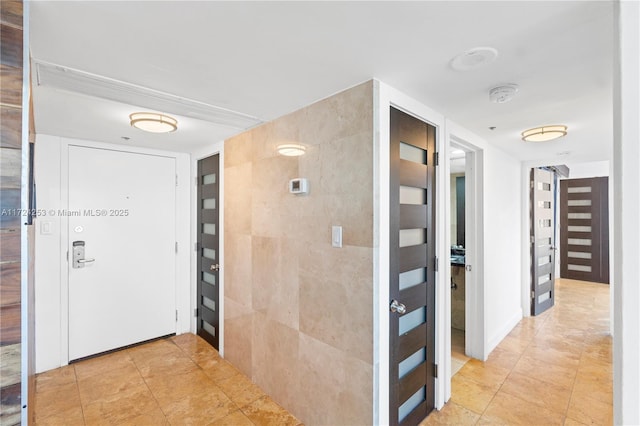 corridor featuring light tile patterned floors