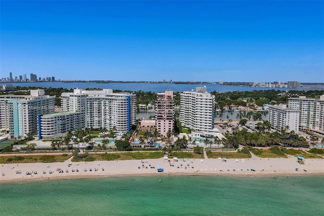 birds eye view of property featuring a water view and a beach view