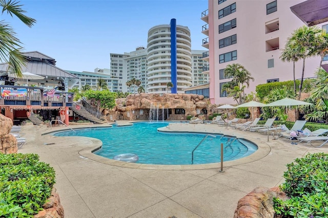 view of swimming pool featuring pool water feature and a patio