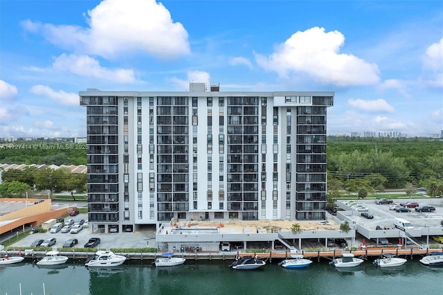 2500 NE 135th St Unit B206, North Miami, FL 33181 - view of building exterior featuring a water view and uncovered parking