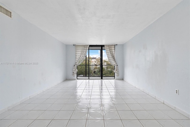 2500 NE 135th St Unit B206, North Miami, FL 33181 - unfurnished room featuring expansive windows and a textured ceiling