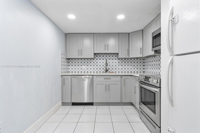 2500 NE 135th St Unit B206, North Miami, FL 33181 - kitchen featuring stainless steel appliances, gray cabinetry, light countertops, tasteful backsplash, and recessed lighting