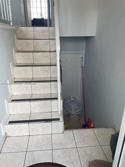 staircase with tile patterned floors