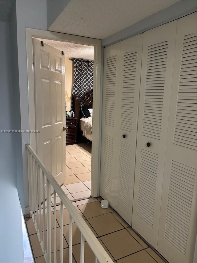 corridor featuring light tile patterned floors