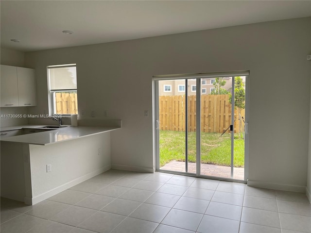 kitchen featuring sink, white cabinets, and light tile patterned floors