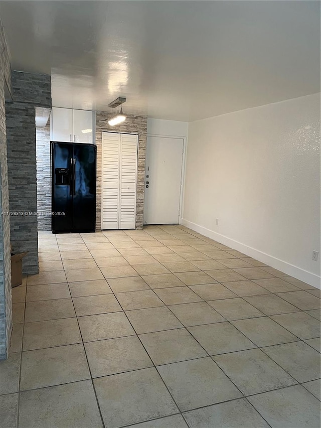 unfurnished living room featuring light tile patterned floors