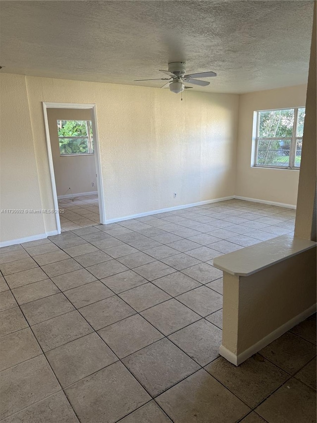 unfurnished room featuring ceiling fan and light tile patterned floors