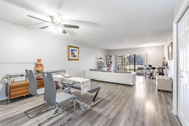 interior space with light wood-type flooring, a textured ceiling, and ceiling fan