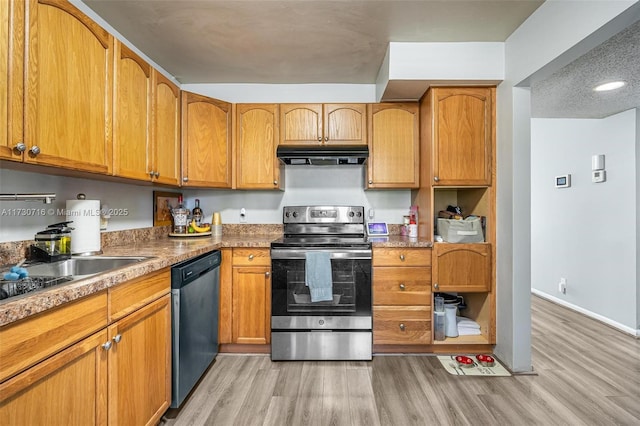 kitchen featuring range hood, light hardwood / wood-style flooring, and appliances with stainless steel finishes