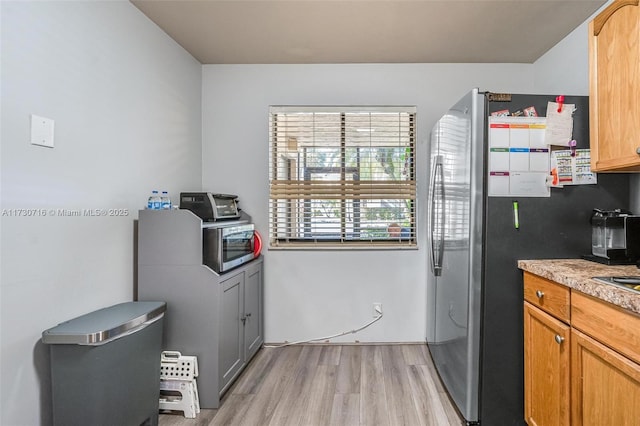 kitchen featuring light hardwood / wood-style flooring and appliances with stainless steel finishes